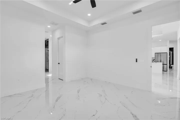 Spare room with recessed lighting and a ceiling fan