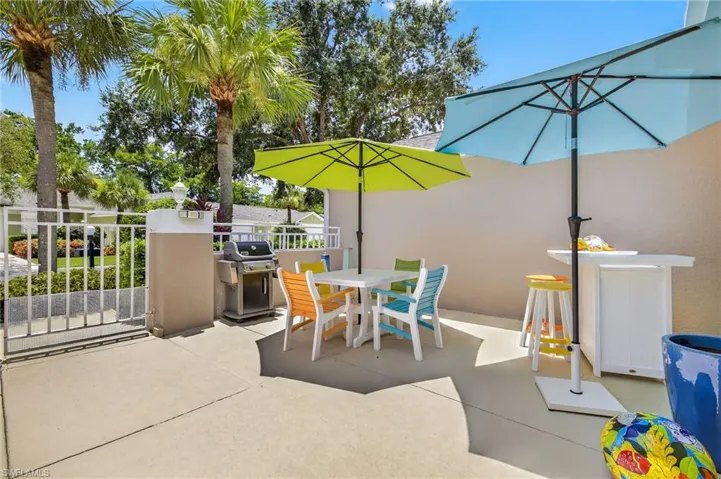 View of patio featuring a grill and outdoor dining space