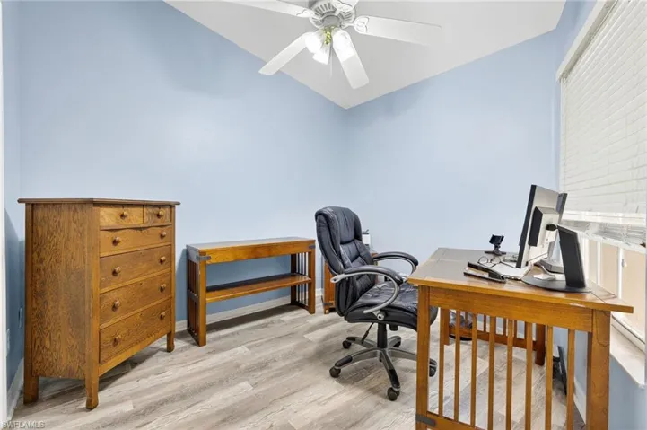 Office featuring light wood finished floors, lofted ceiling, and ceiling fan