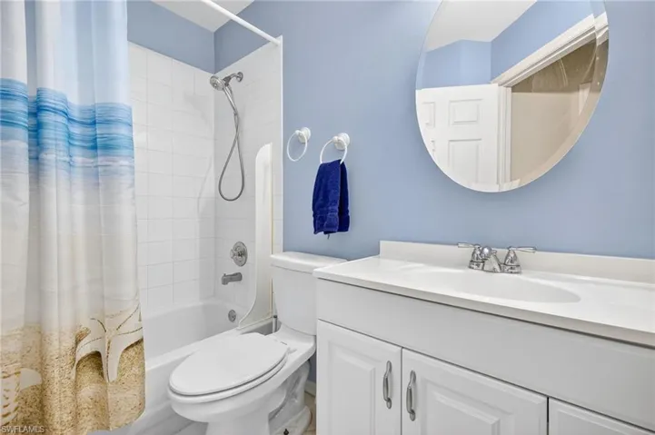 Full bathroom with shower / bath combo and vanity
