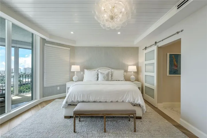 Primary suite with frosted glass barn door into the bath en suite.