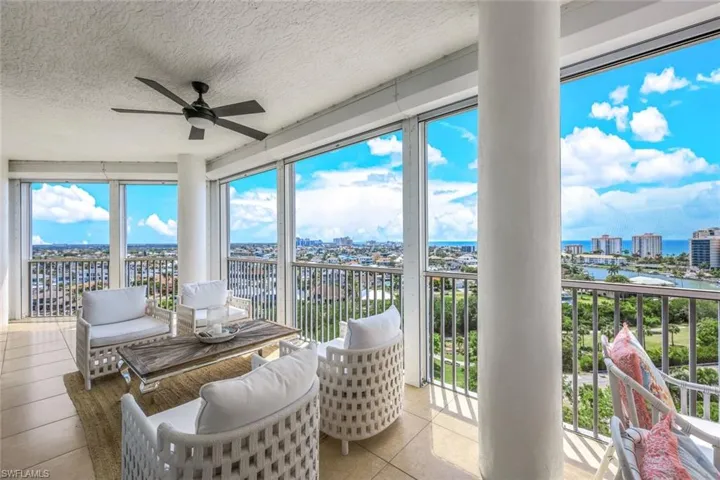 Seating area on lanai with beautiful views of gulf and city scape.