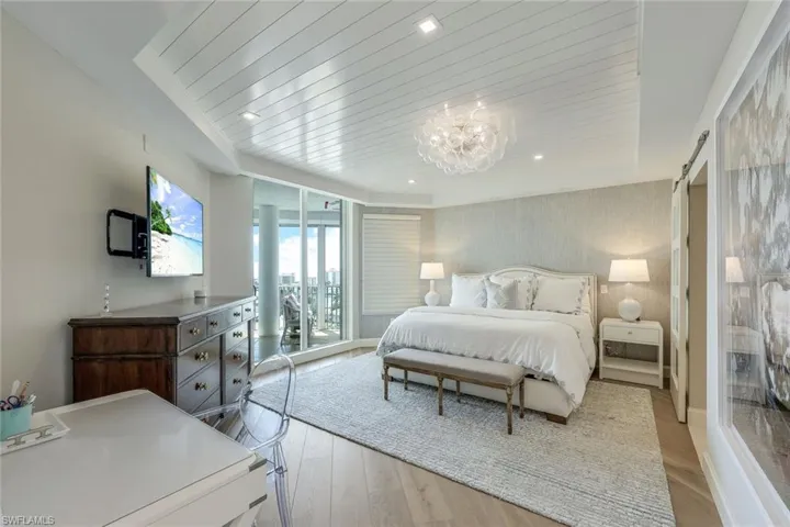 Primary suite with nickel gap ceiling paneling.  Gorgeous light fixtures throughout.