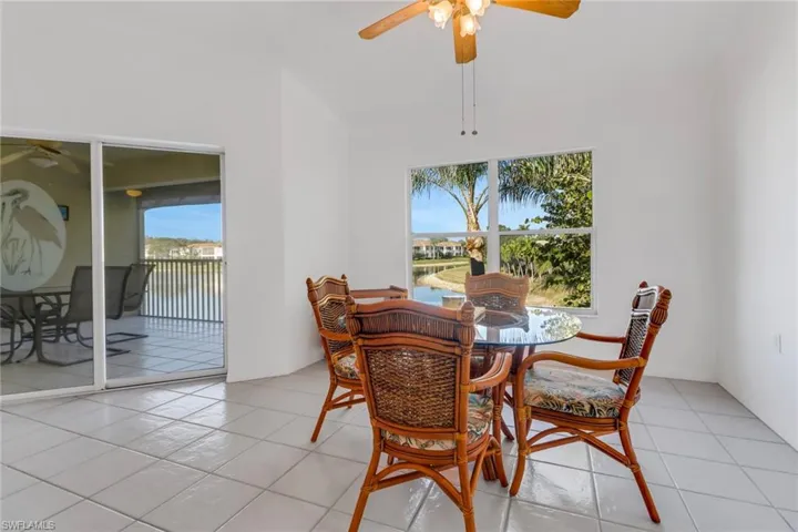 Tiled dining room featuring ceiling fan