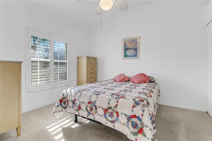 Bedroom featuring light colored carpet and ceiling fan