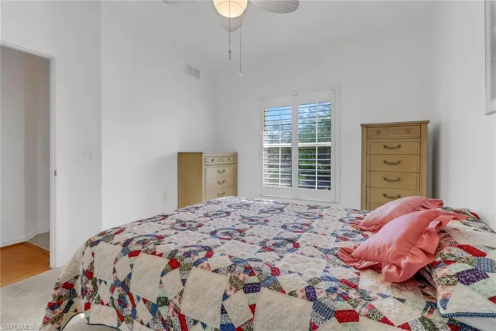 Bedroom with hardwood / wood-style floors and ceiling fan