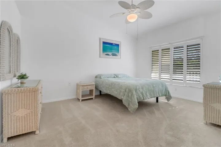 Bedroom featuring light carpet and ceiling fan