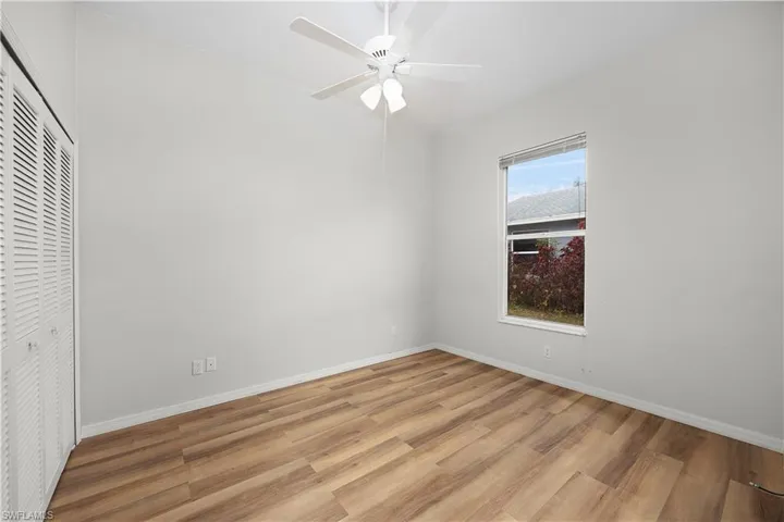 Unfurnished bedroom with light wood finished floors, a closet, and ceiling fan