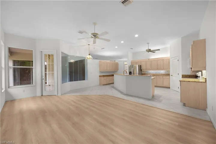 Unfurnished living room with a ceiling fan, light wood-style flooring, and recessed lighting