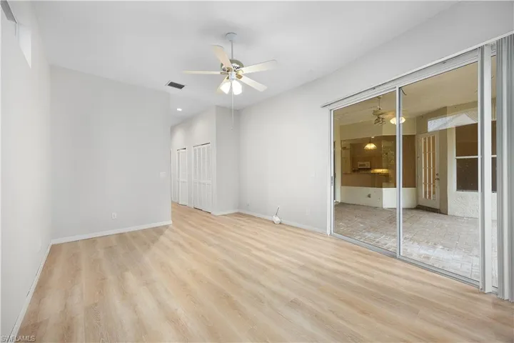 Unfurnished bedroom with a closet, light wood finished floors, a ceiling fan, and access to outside
