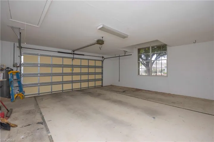 Garage with water heater and a garage door opener