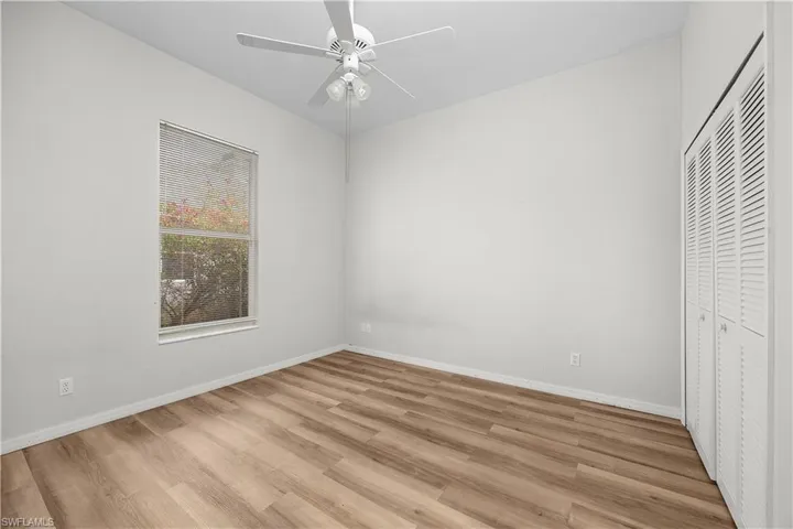 Unfurnished bedroom featuring light wood finished floors, a closet, and ceiling fan