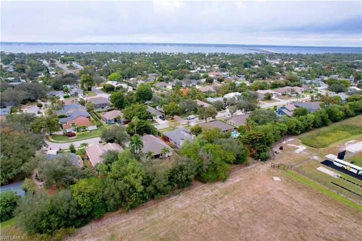 View of property location with nearby suburban area and a nearby body of water