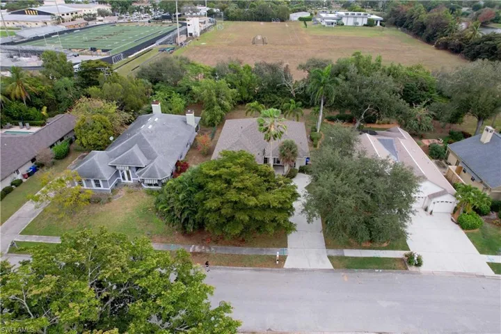 Aerial view of residential area featuring a tree filled landscape