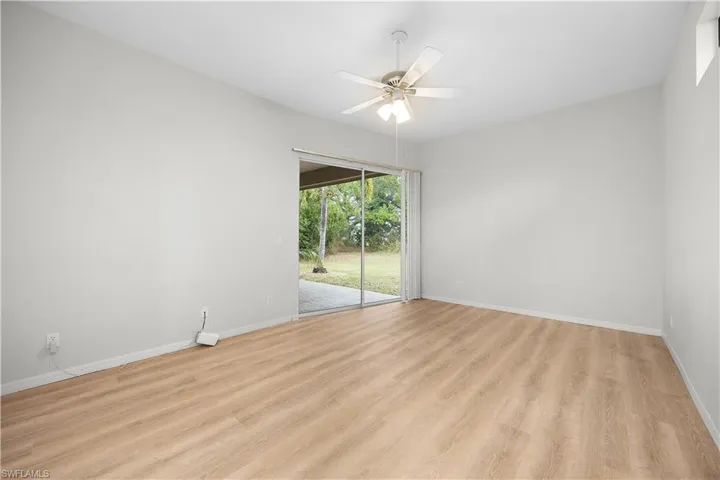 Unfurnished room with light wood finished floors and a ceiling fan