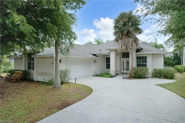 Ranch-style house featuring driveway, stucco siding, roof with shingles, and a garage