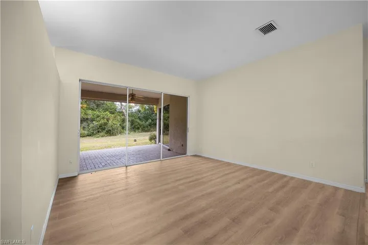 Spare room featuring light wood-style flooring and baseboards