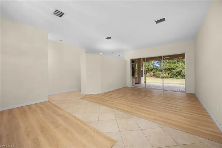Unfurnished room with light tile patterned floors and baseboards