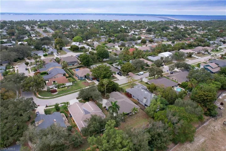 Aerial overview of property's location featuring nearby suburban area and a large body of water