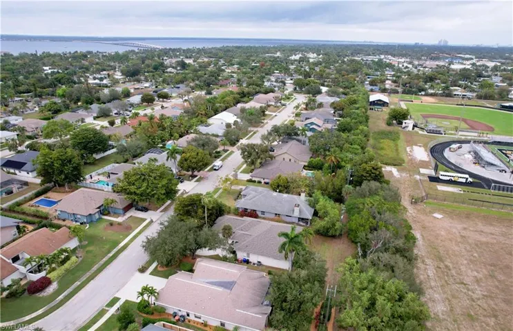 Aerial view of property's location with nearby suburban area and a large body of water