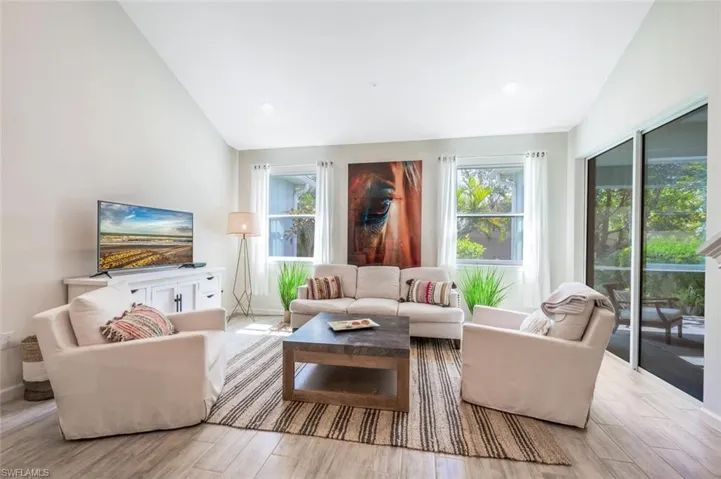 Living area featuring lofted ceiling and wood finished floors