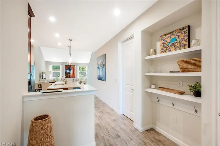 Kitchen with light countertops, light wood-style flooring, a peninsula, pendant lighting, and recessed lighting