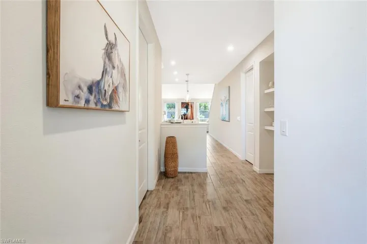 Corridor featuring light wood-type flooring and recessed lighting