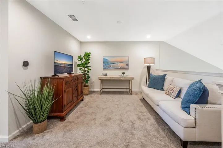 Living area featuring carpet and recessed lighting