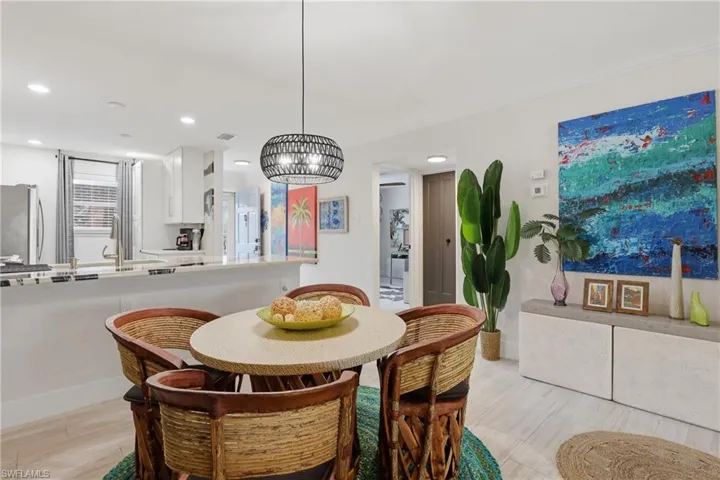 Open-concept dining area with a contemporary pendant light fixture