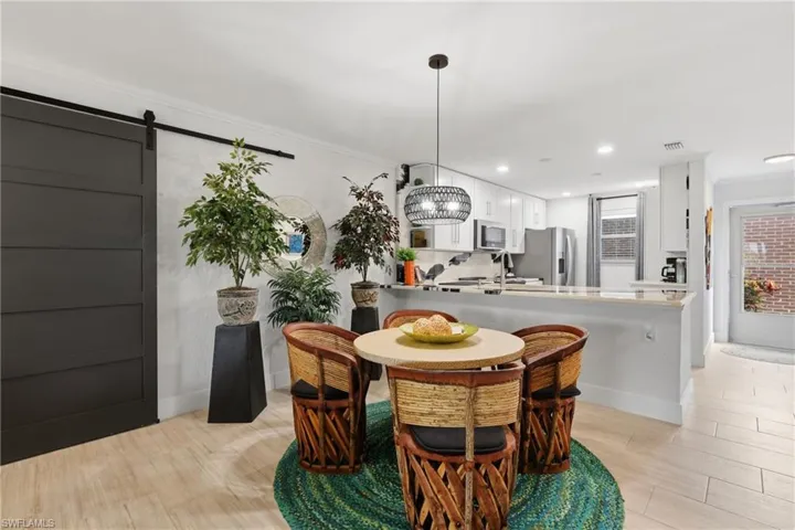 Open-concept kitchen and dining area featuring light wood-finish flooring