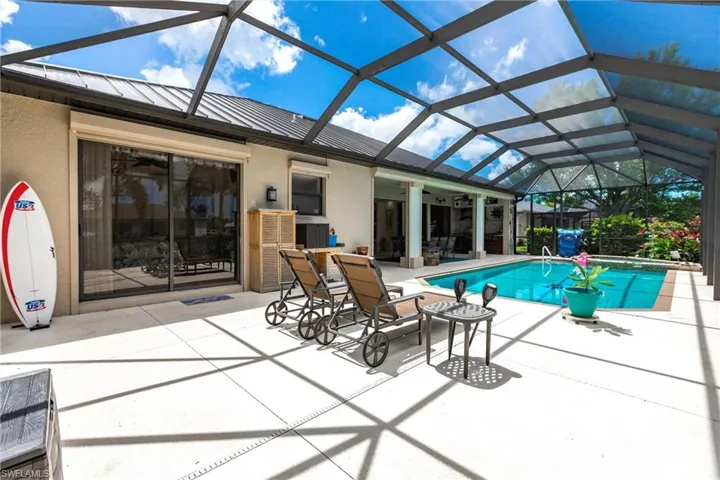 View of swimming pool with a patio and a lanai