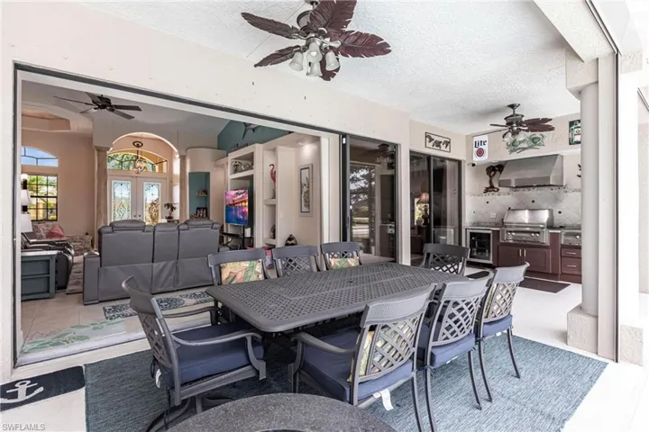 Tiled dining area with ceiling fan, french doors, and a textured ceiling