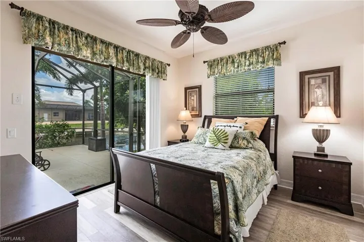 Bedroom featuring hardwood / wood-style floors, ceiling fan, and access to exterior
