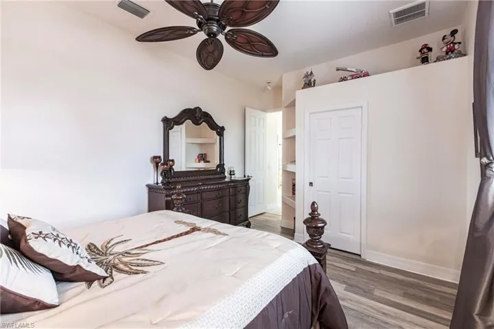 Bedroom with ceiling fan and hardwood / wood-style flooring