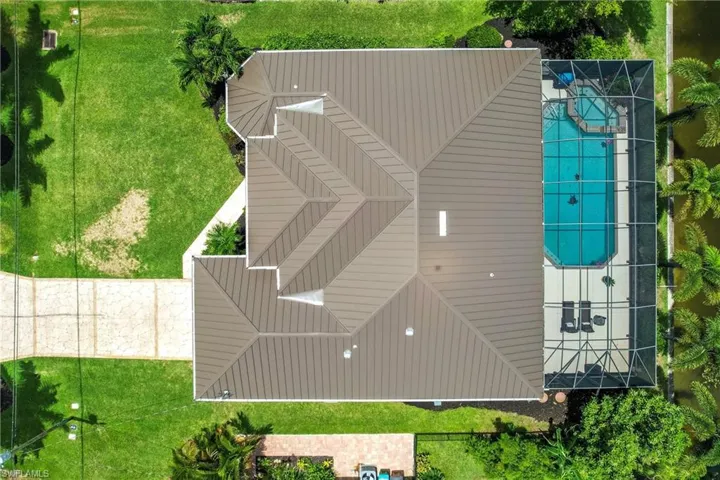 View of front of house with a garage and a front lawn