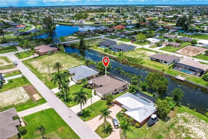 Birds eye view of property with a water view