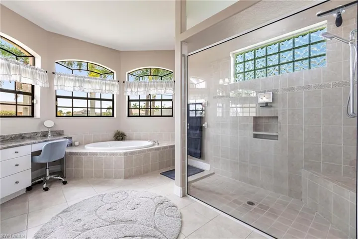 Bathroom with tile floors and plus walk in shower