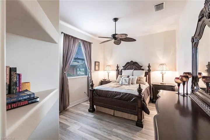 Bedroom with ceiling fan and light hardwood / wood-style floors