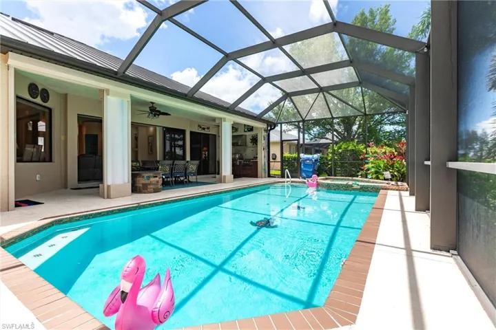 View of pool with a patio, a lanai, and ceiling fan