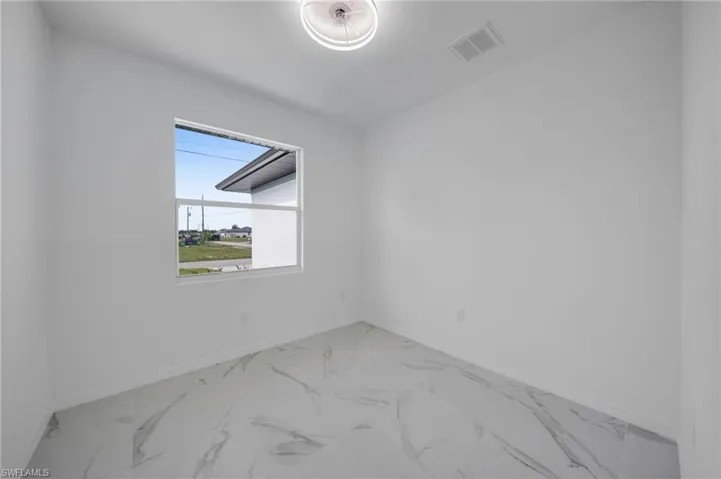 Unfurnished room with light marble finish flooring