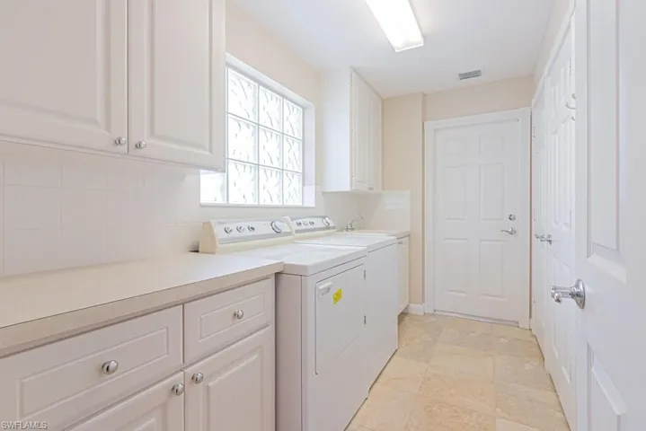 Laundry room with cabinet space and separate washer and dryer
