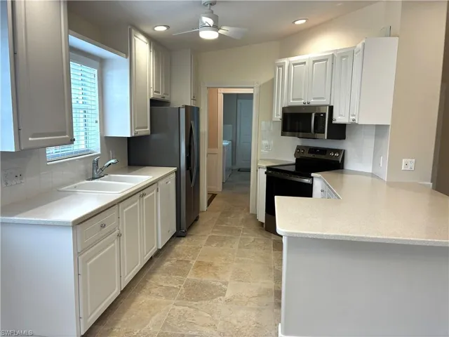 Kitchen with new faucet & new  stainless steel finishes, freshly cleaned grout
