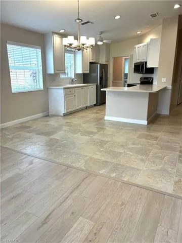 Kitchen featuring new lighting & brand new stainless steel appliances