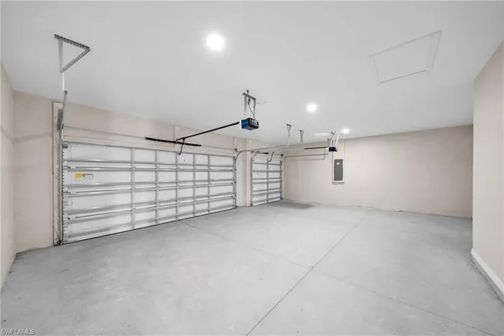 Garage with electric panel and a garage door opener