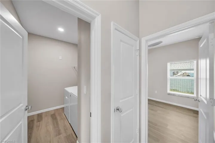 Washroom featuring washing machine and dryer and light wood-type flooring