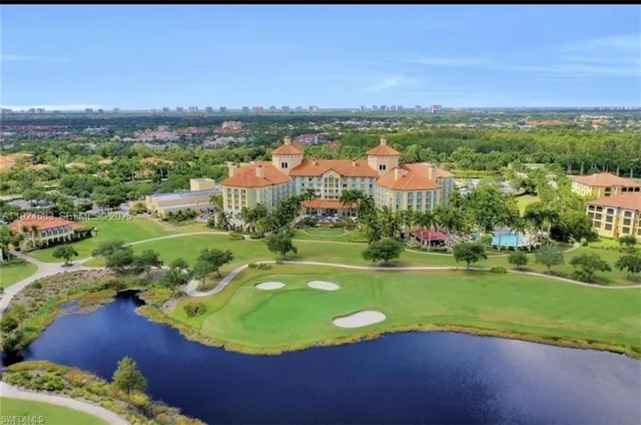 This property offers an expansive golf course with a visible water feature, surrounded by lush green landscaping and mature trees