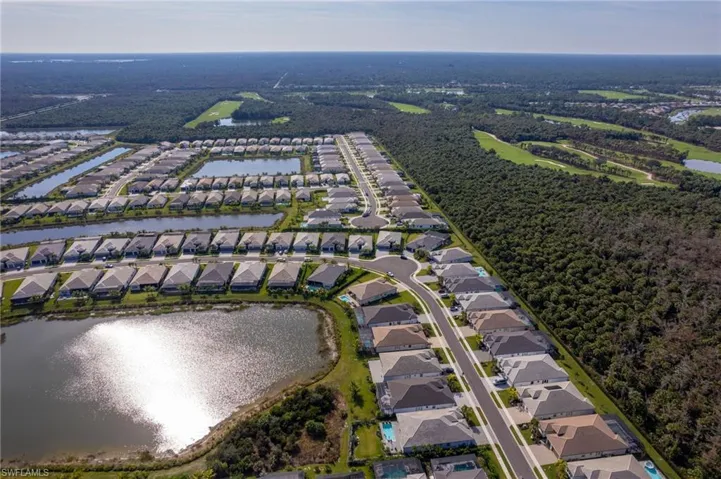 Aerial view of property's location featuring a large body of water and nearby suburban area