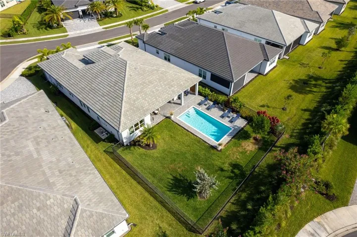 Aerial view of residential area featuring a pool