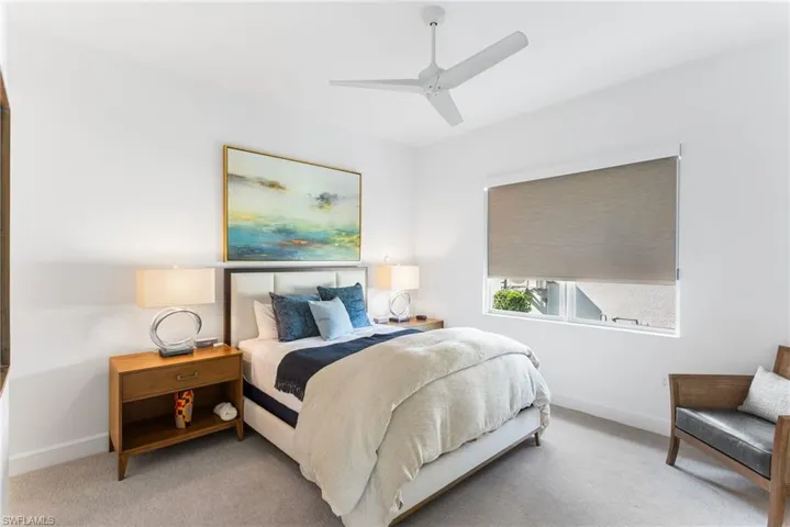 Bedroom featuring a ceiling fan and carpet floors