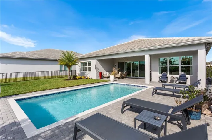View of pool with an outdoor living space and a patio